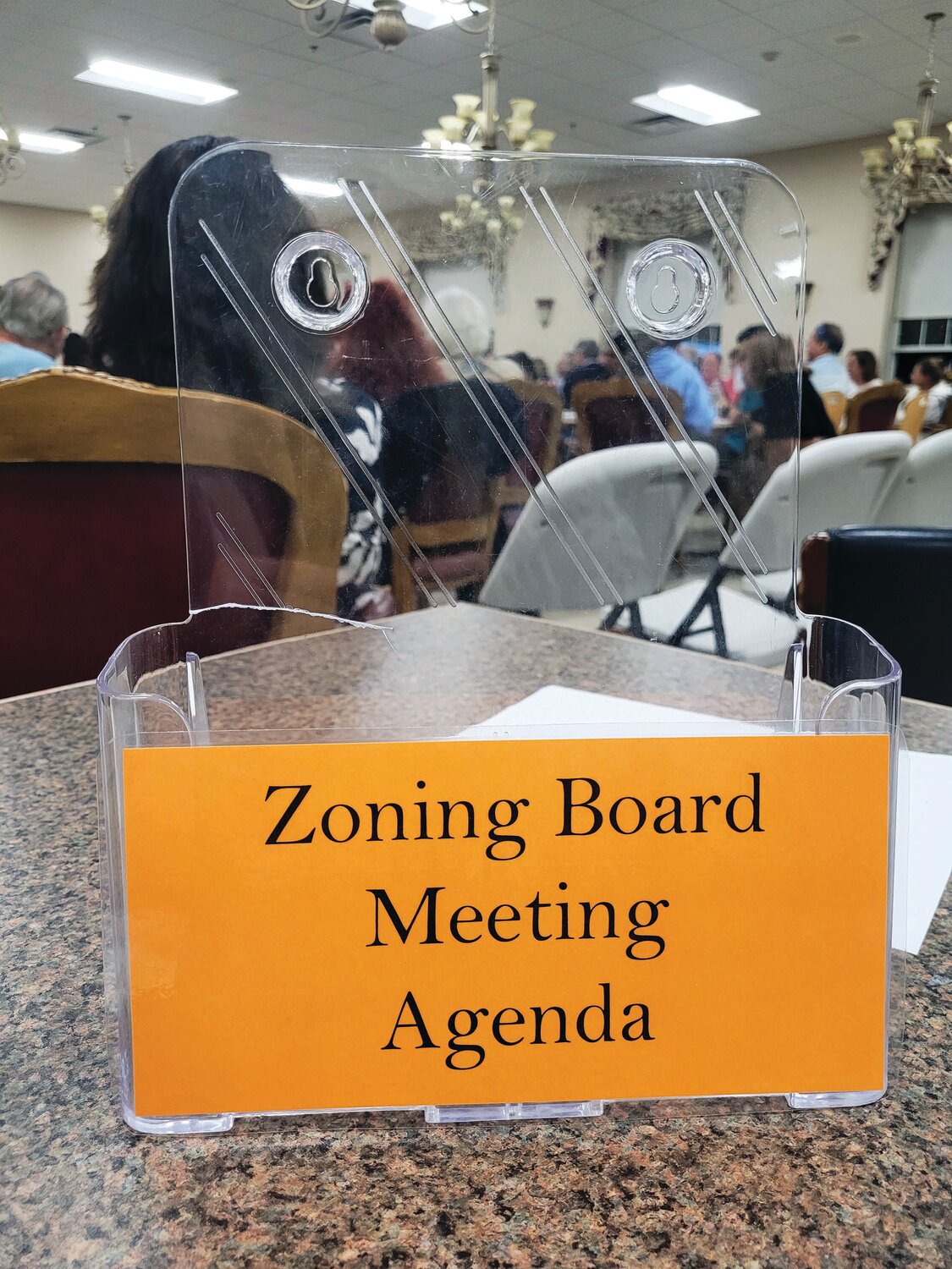 CRAVING SUNSHINE: The agenda rack was picked clean at last Thursday’s Zoning Board meeting. For a while, it was standing-room-only at the Senior Center.